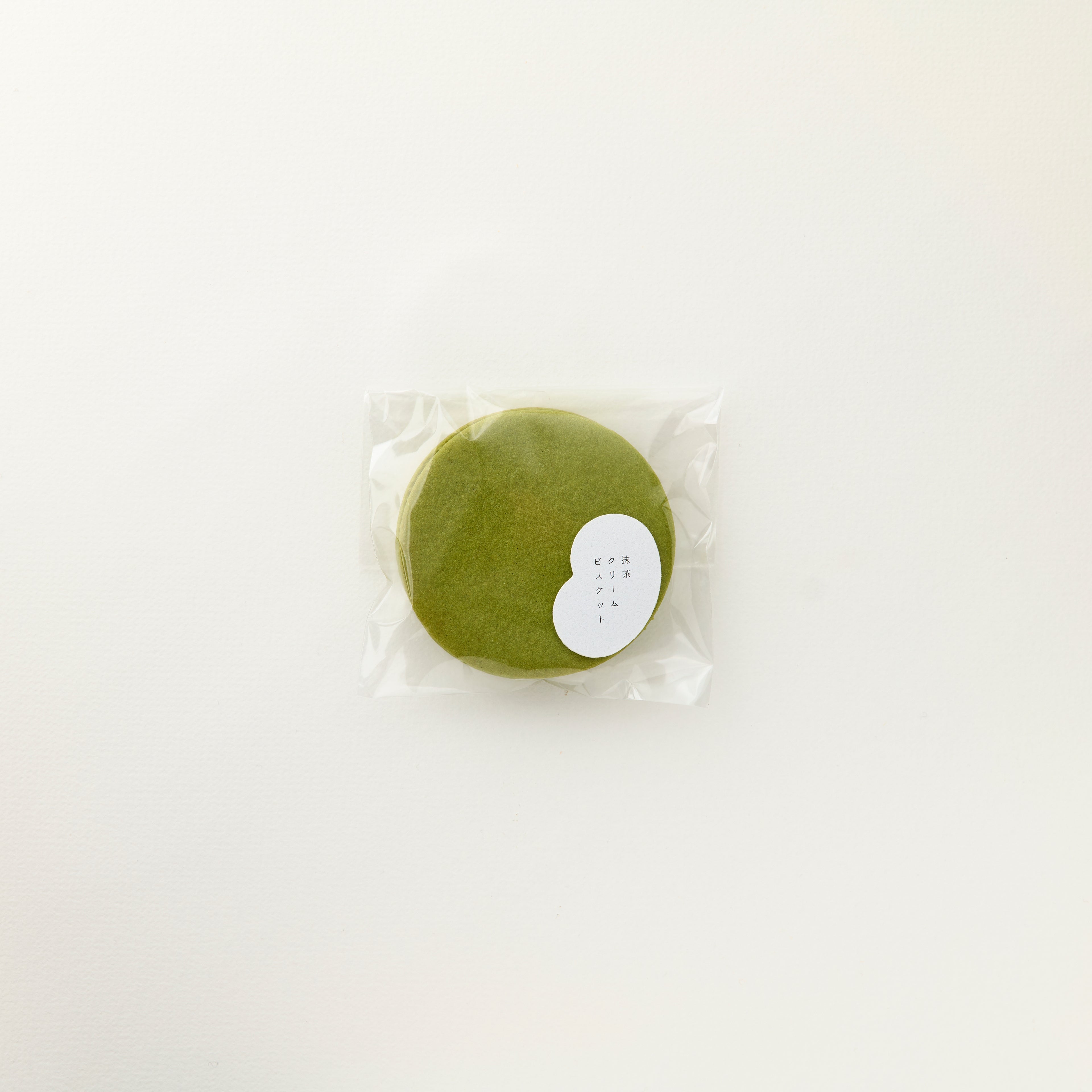 MATCHADO Matcha Cream Biscuit - Artisanal Handcrafted - 100% Japanese Matcha. Matcha round cookie in clear packaging on a white background