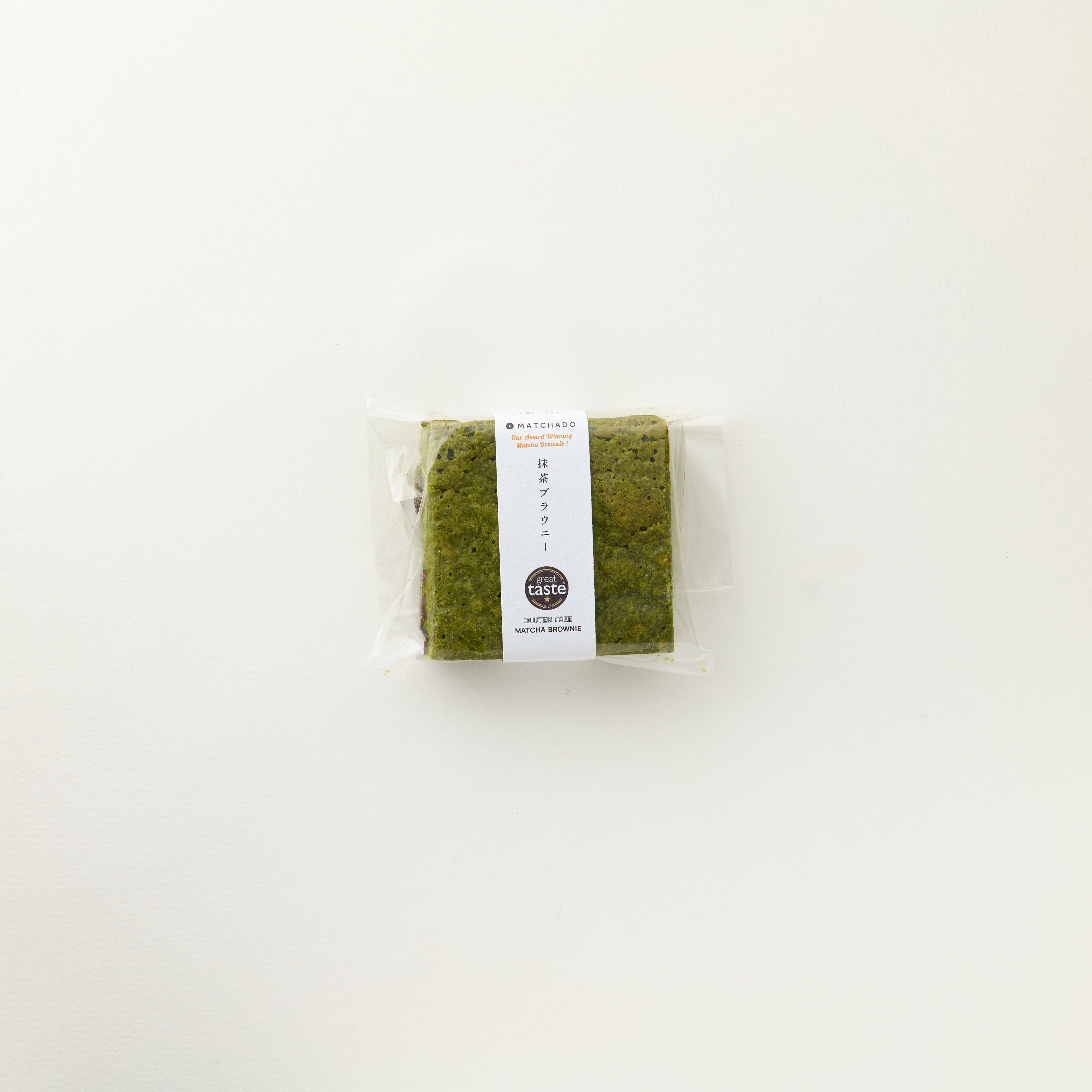 MATCHADO Gluten-Free Matcha Brownie - Dark Chocolate - Great Taste Award Winner. Packaged green tea with a label on a white background