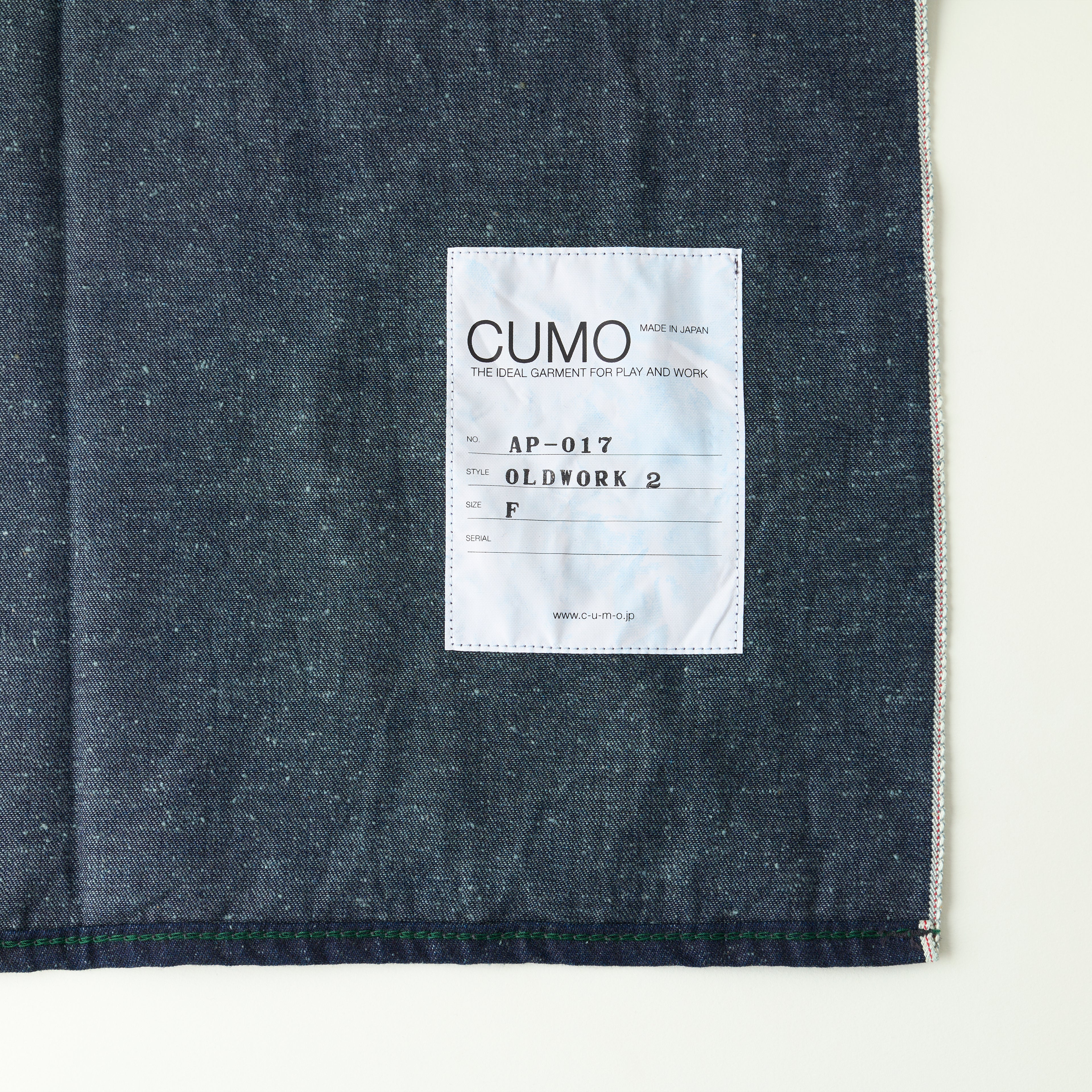 Dark denim fabric with a label on a white background