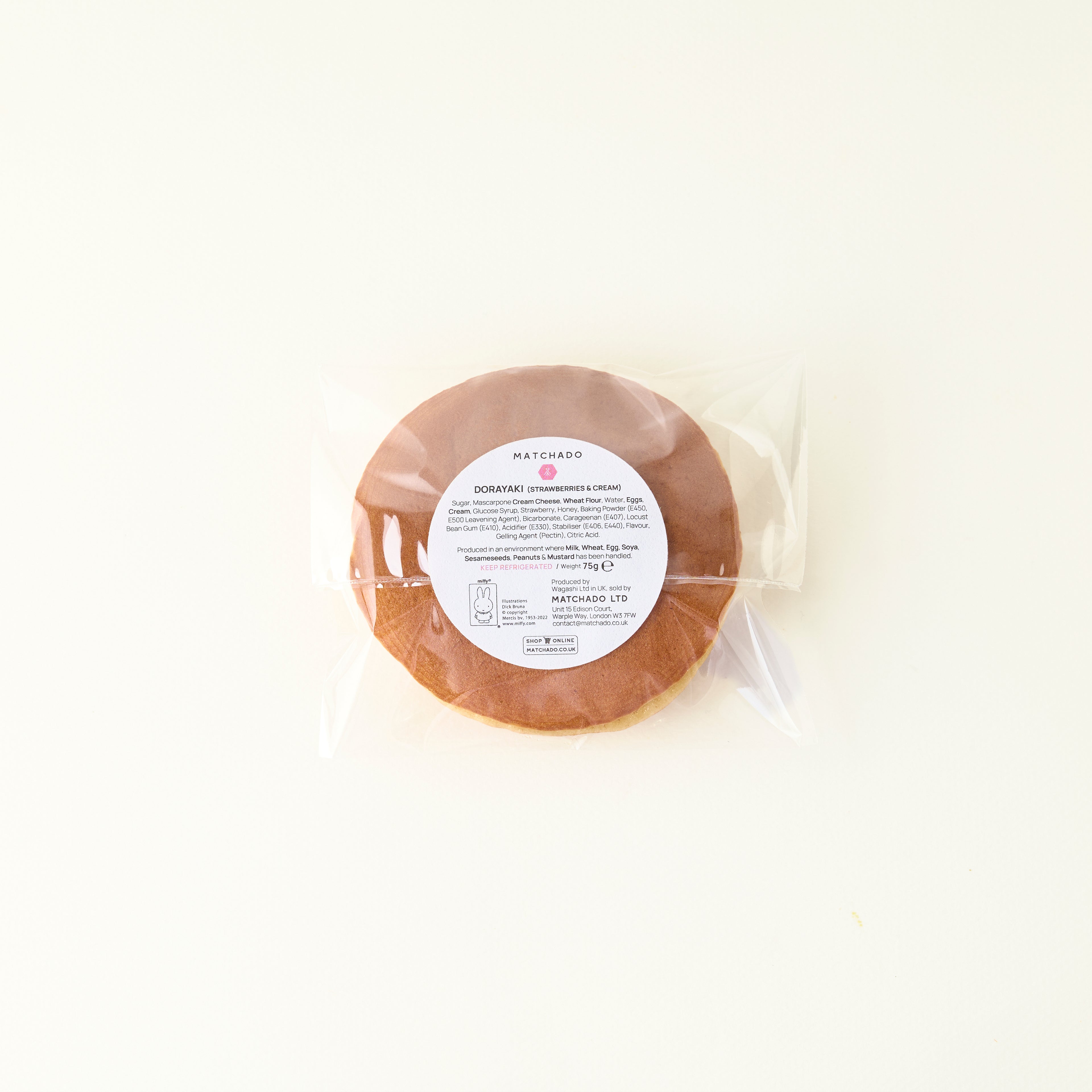 Round package of food with a label on a white background