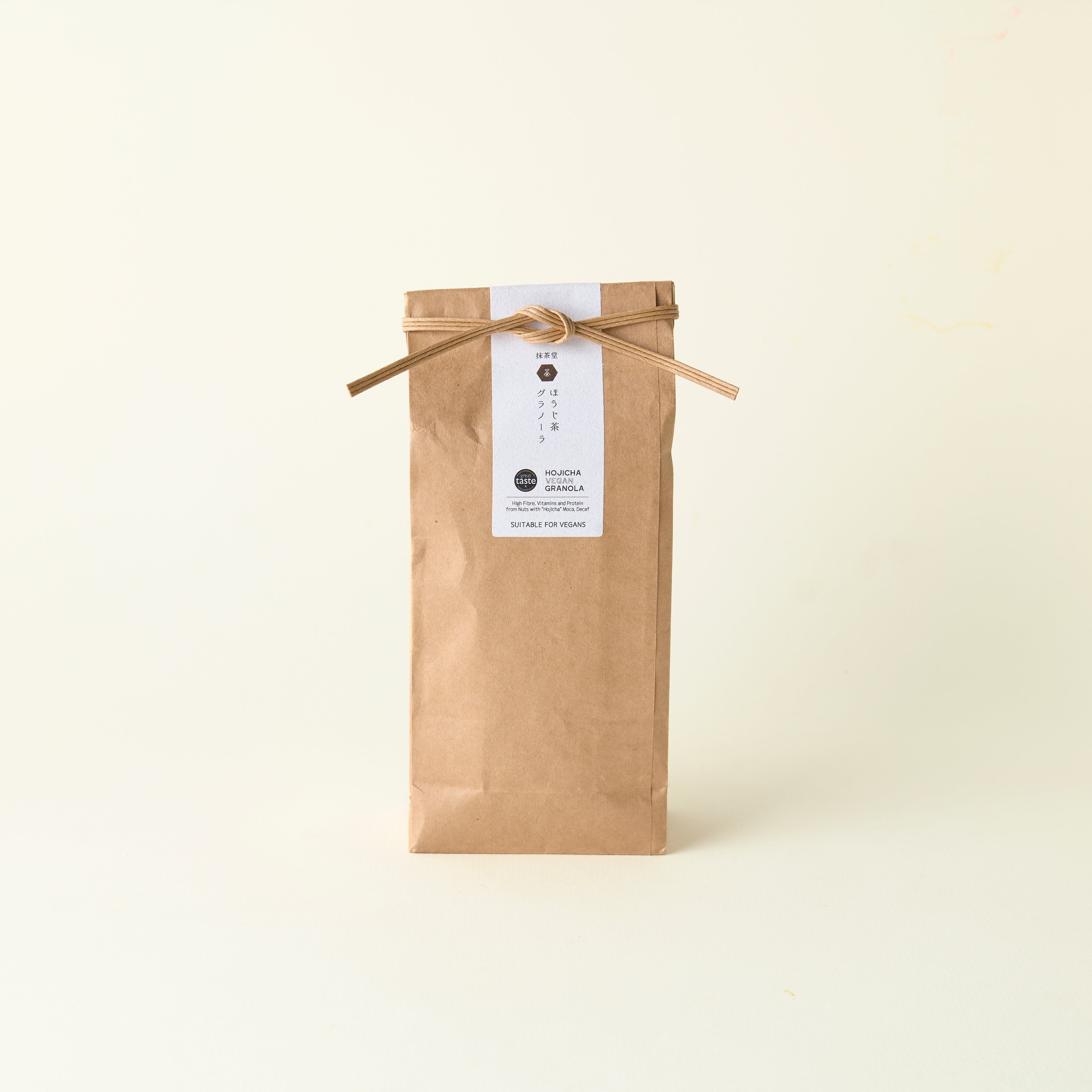 Hojicha Granola. Craft paper bag with a label on a white background.