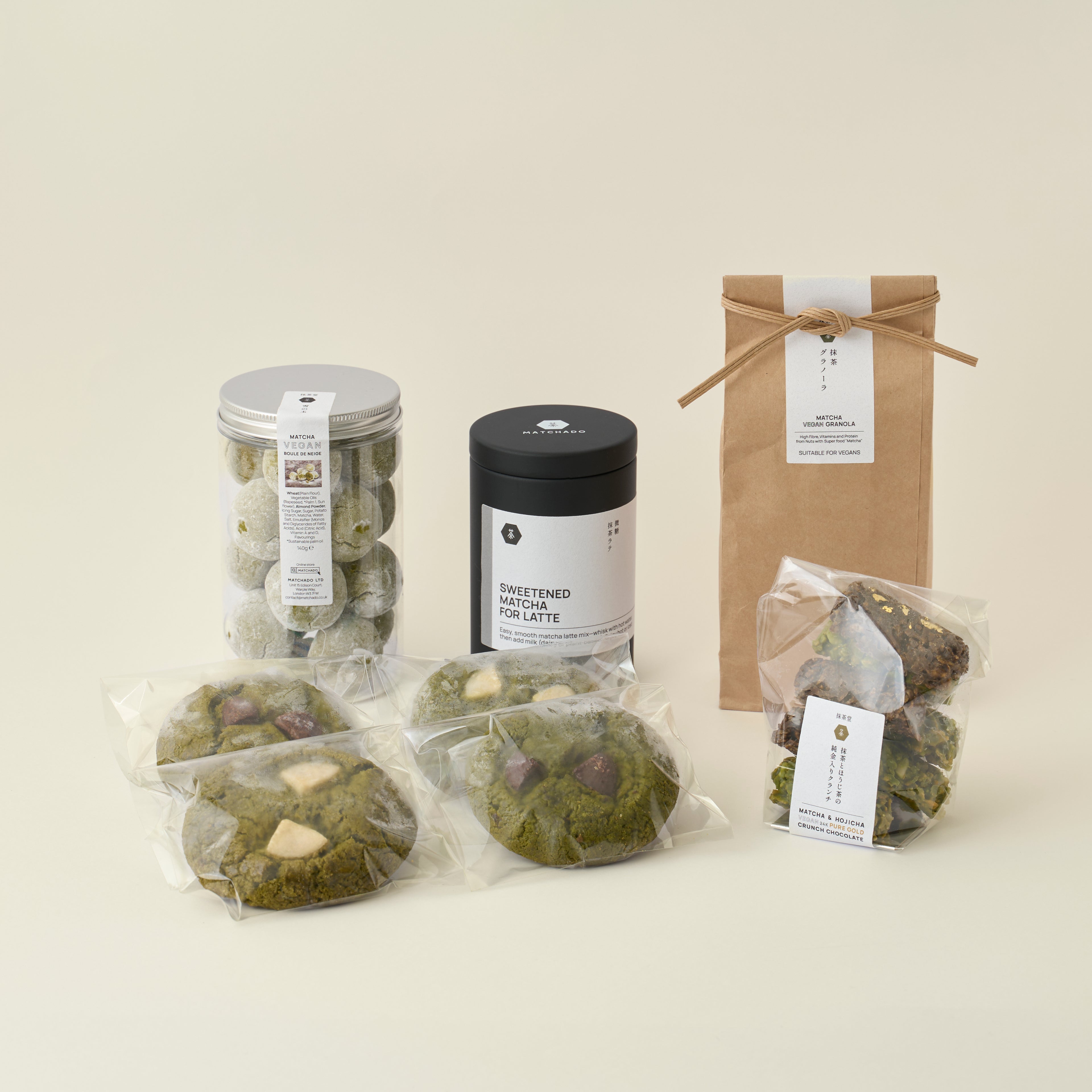 MATCHADO Vegan Sweets Box - Plant-Based Matcha & Hojicha Treats . Assorted food items including cookies, a canister, and a box on a light background