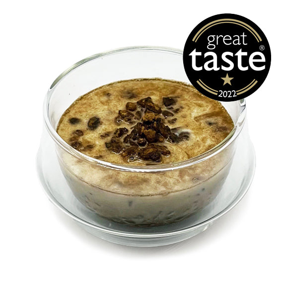 A bowl of granola, topped with hojicha powder, with a &