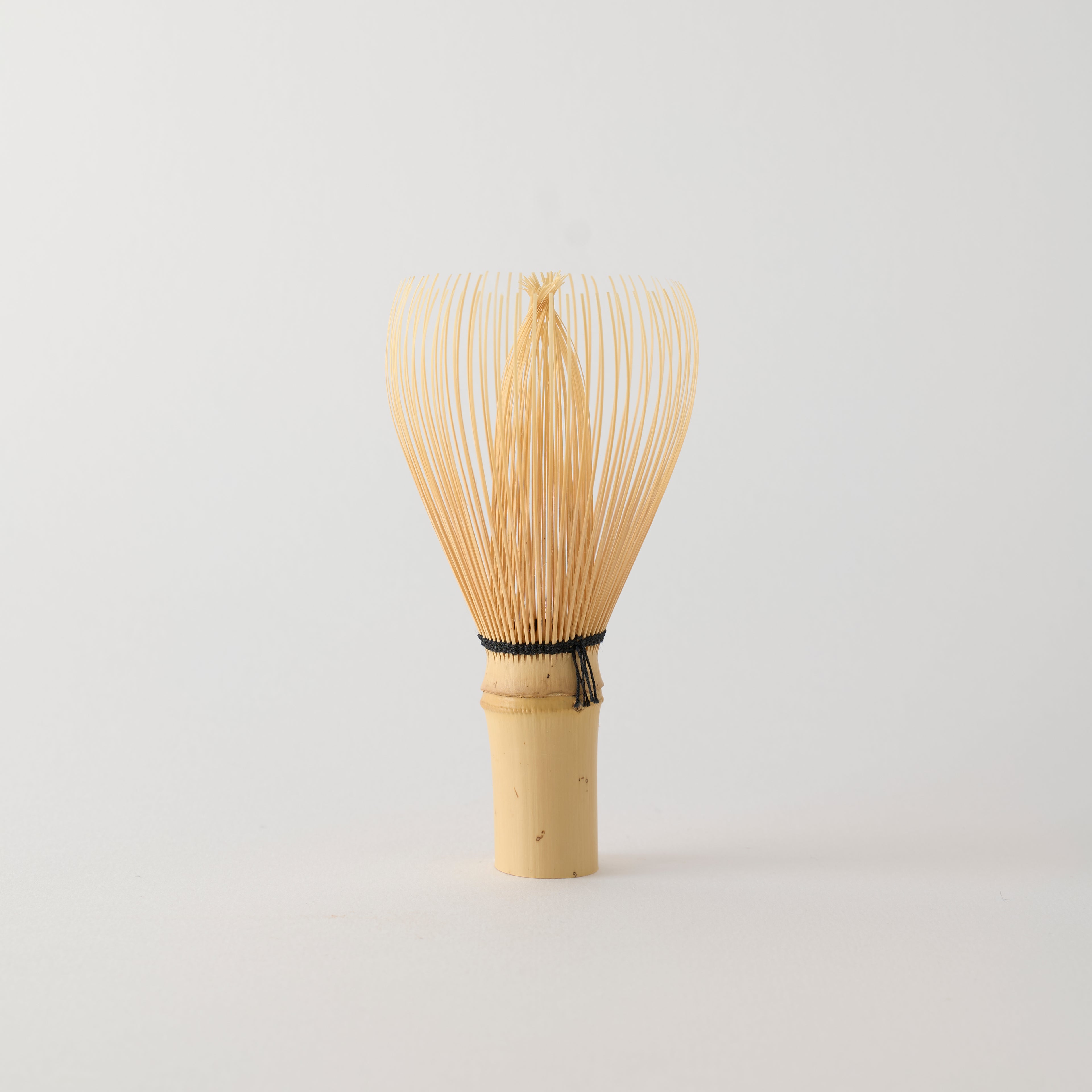 MATCHADO Shin-Kazuho Takayama Bamboo Whisk - Hand Made in JAPAN. Bamboo whisk on a light gray background