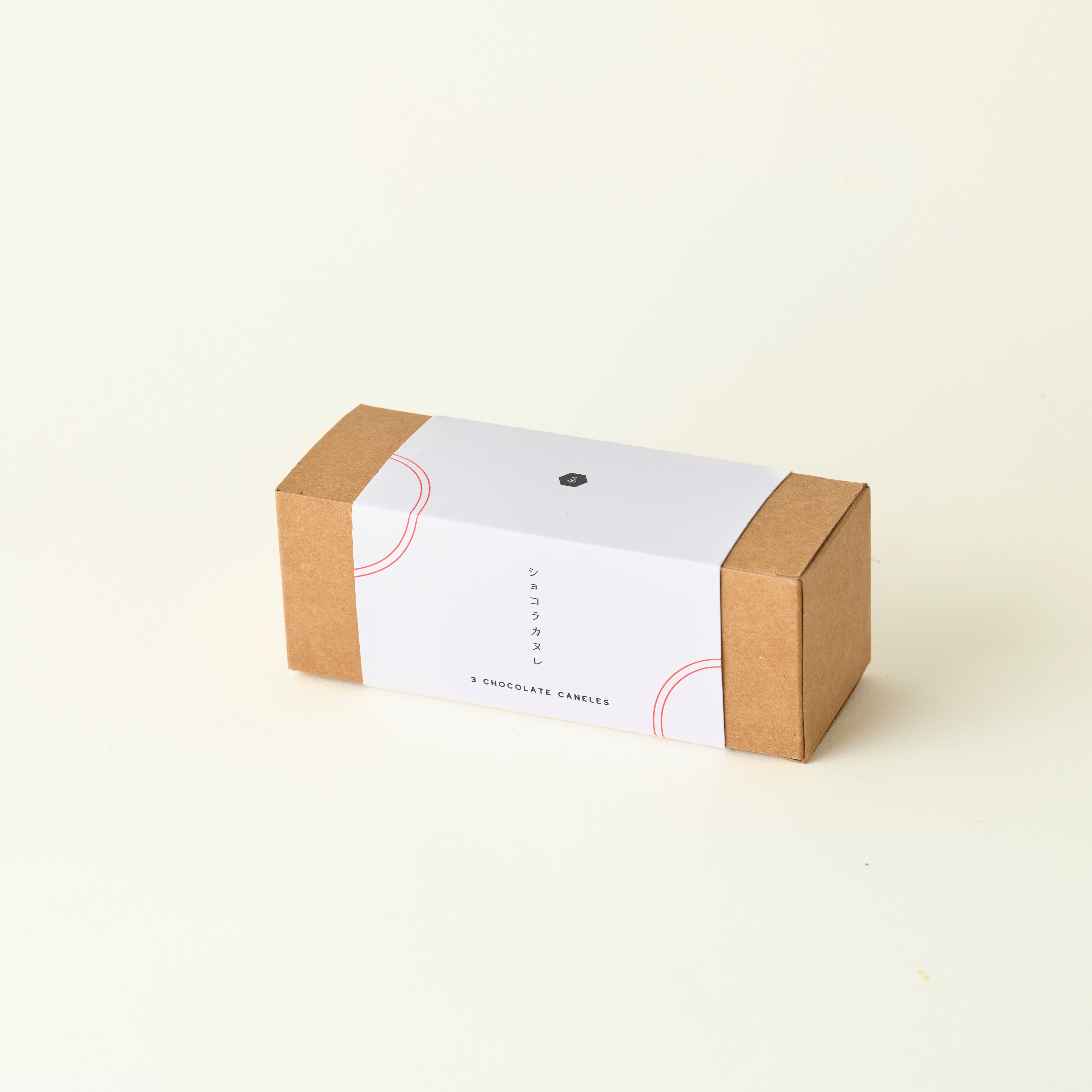 Small brown box with a white label on a beige background