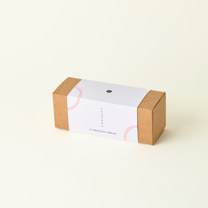 Small brown box with a white label on a beige background
