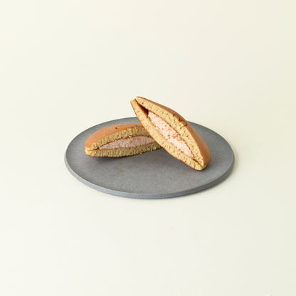 Two halves of a dorayaki on a gray plate against a light beige background
