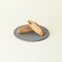 Two halves of a dorayaki on a gray plate against a light beige background