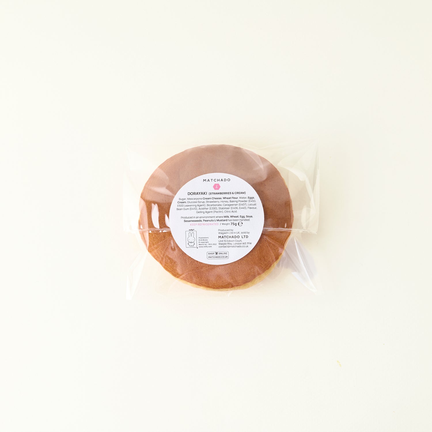 Round package of food with a label on a white background