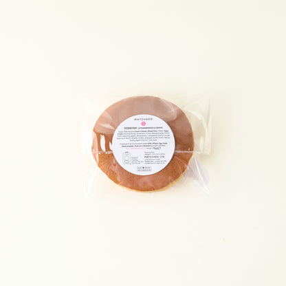 Round package of food with a label on a white background