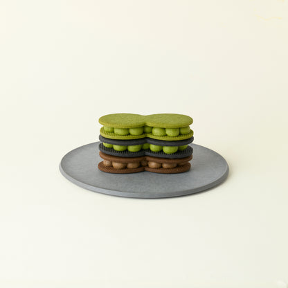 MATCHADO Japanese Cream Biscuit Trio. Stack of green cookies on a gray plate with a white background