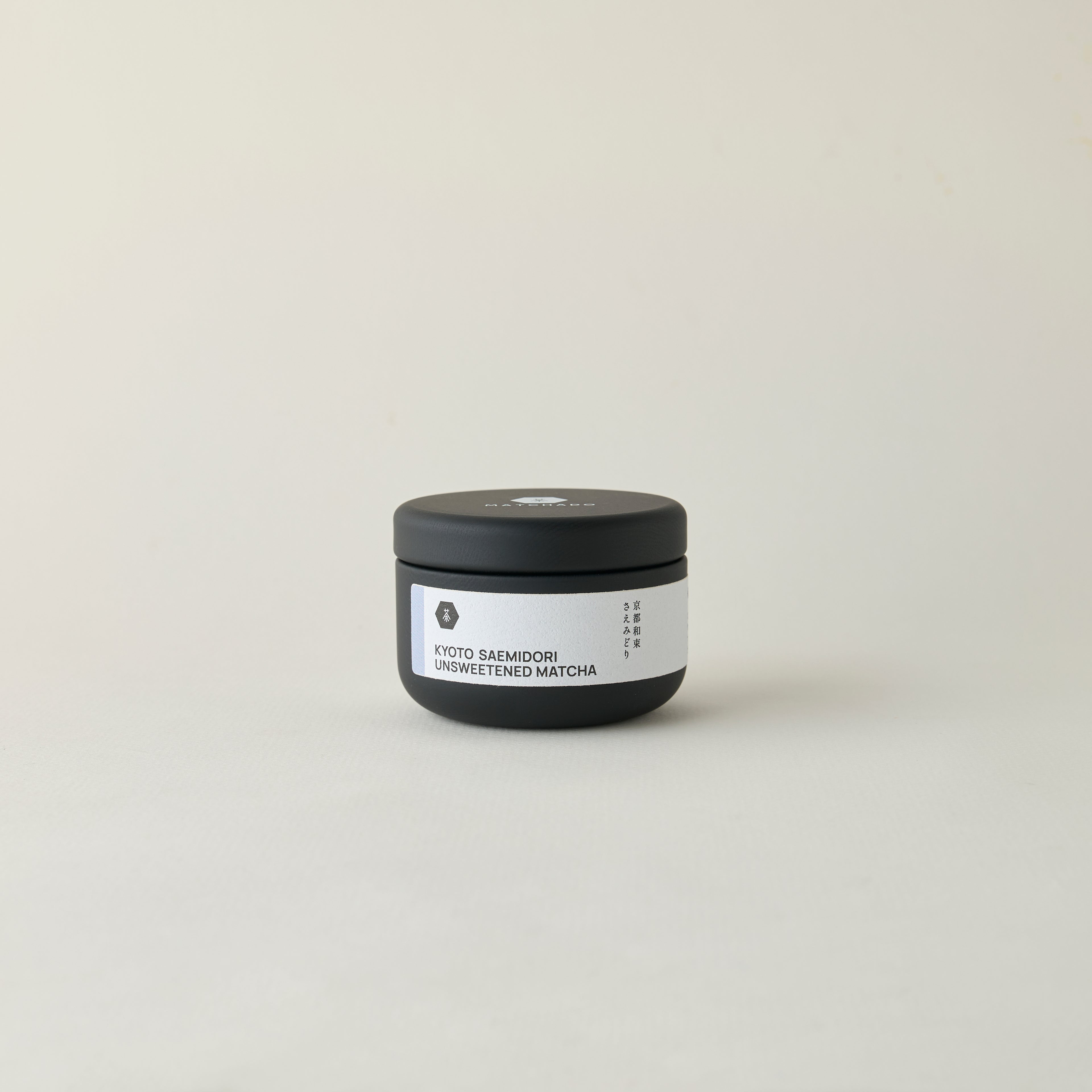 MATCHADO Kyoto Saemidori Unsweetened Matcha (NEW) - Single Origin - Bright Green &amp; Delicate Floral Notes. Small black container with a white label on a light gray background