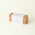 Brown cardboard box with a white label on a beige background