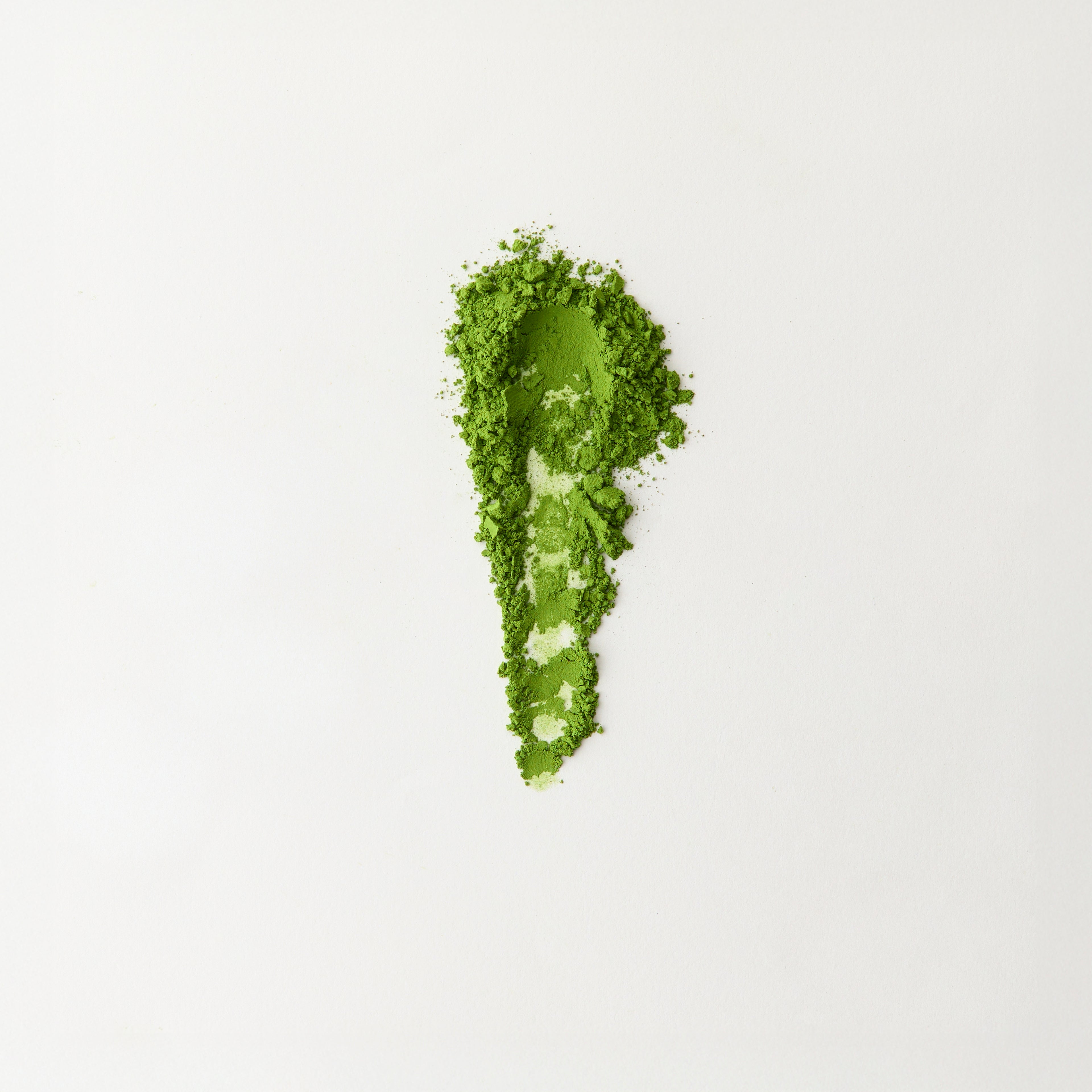 MATCHADO Nagasaki Premium Matcha. Spoonful of green powder on a white background.