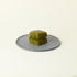 MATCHADO Matcha Scones. A scone on a round metallic plate with a white background