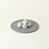 MATCHADO Vegan Boule de Neige Biscuits - Matcha or Strawberry Flavour. Round gray stone on a light beige background