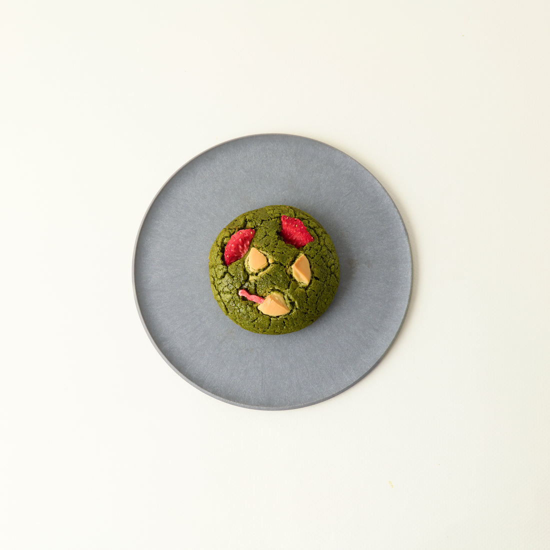 Matcha x Strawberry &amp; White Chocolate Cookie on a gray plate. 