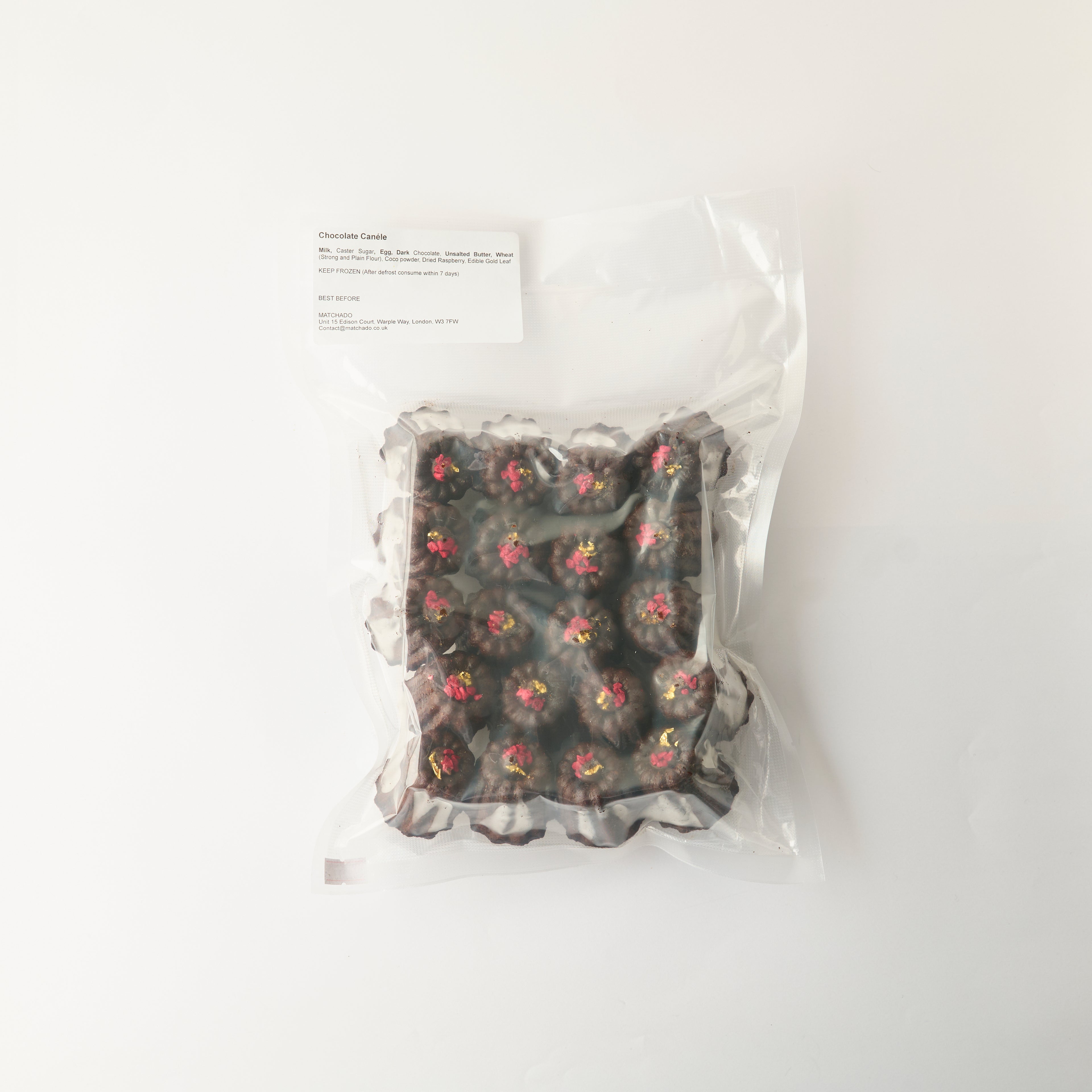 Wholesale pack of Chocolate Canelés in vacuum-sealed packaging. This 20-piece pack shows the product as it arrives, securely sealed to ma
intain freshness.